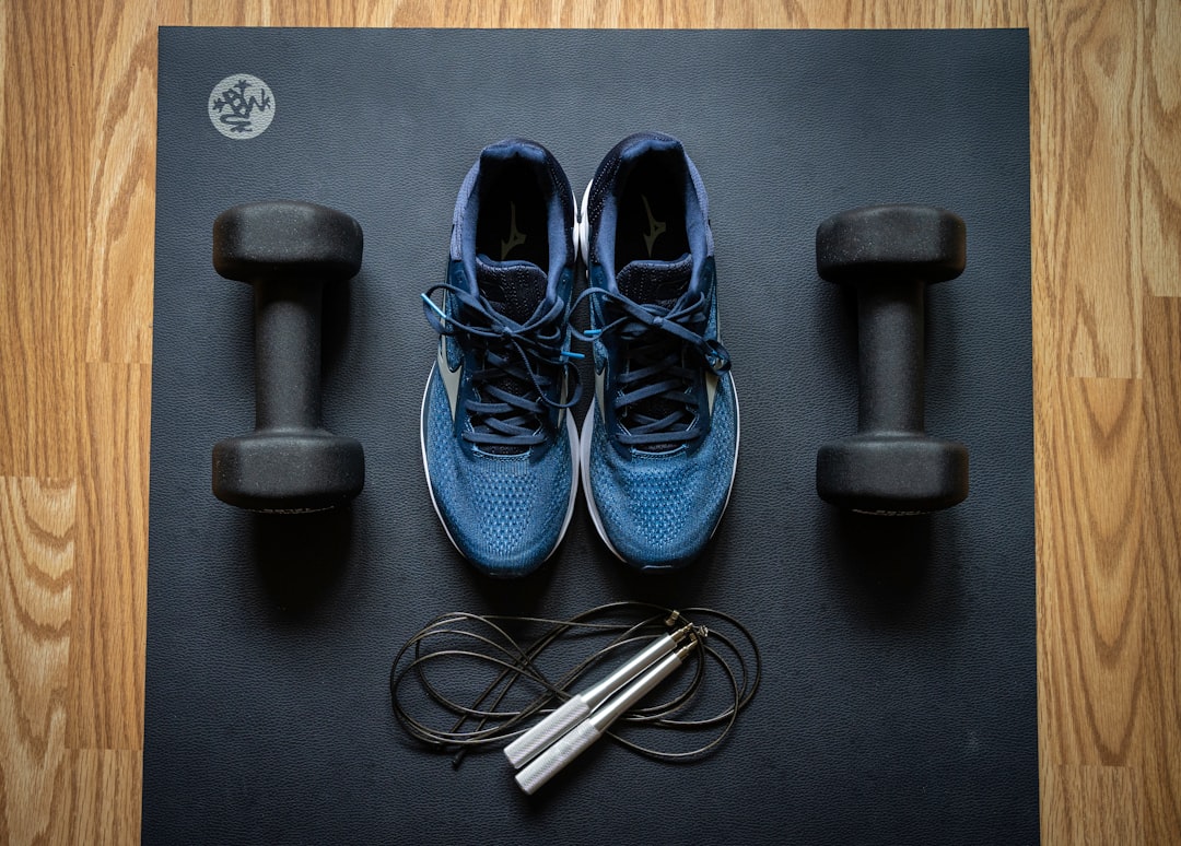A variety of small fitness equipment for home use, including resistance bands, dumbbells, kettlebells, and a mini stepper, arranged in a bright and inviting home setting.