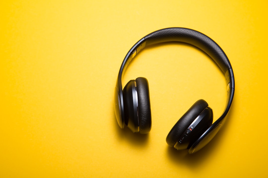 A person testing different headphones in a cozy environment, showcasing various styles and colors.