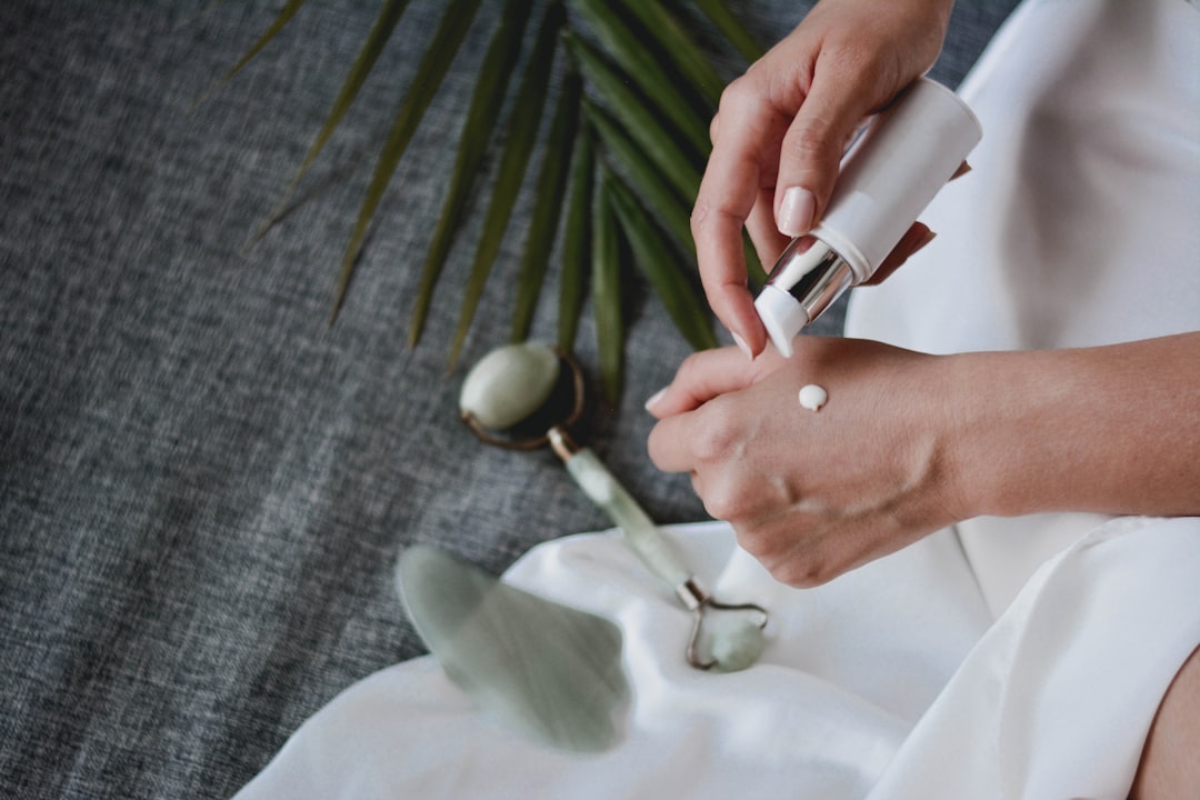 A serene flat lay of various skincare products including creams, serums, and natural ingredients like aloe vera and essential oils, arranged aesthetically on a light background.